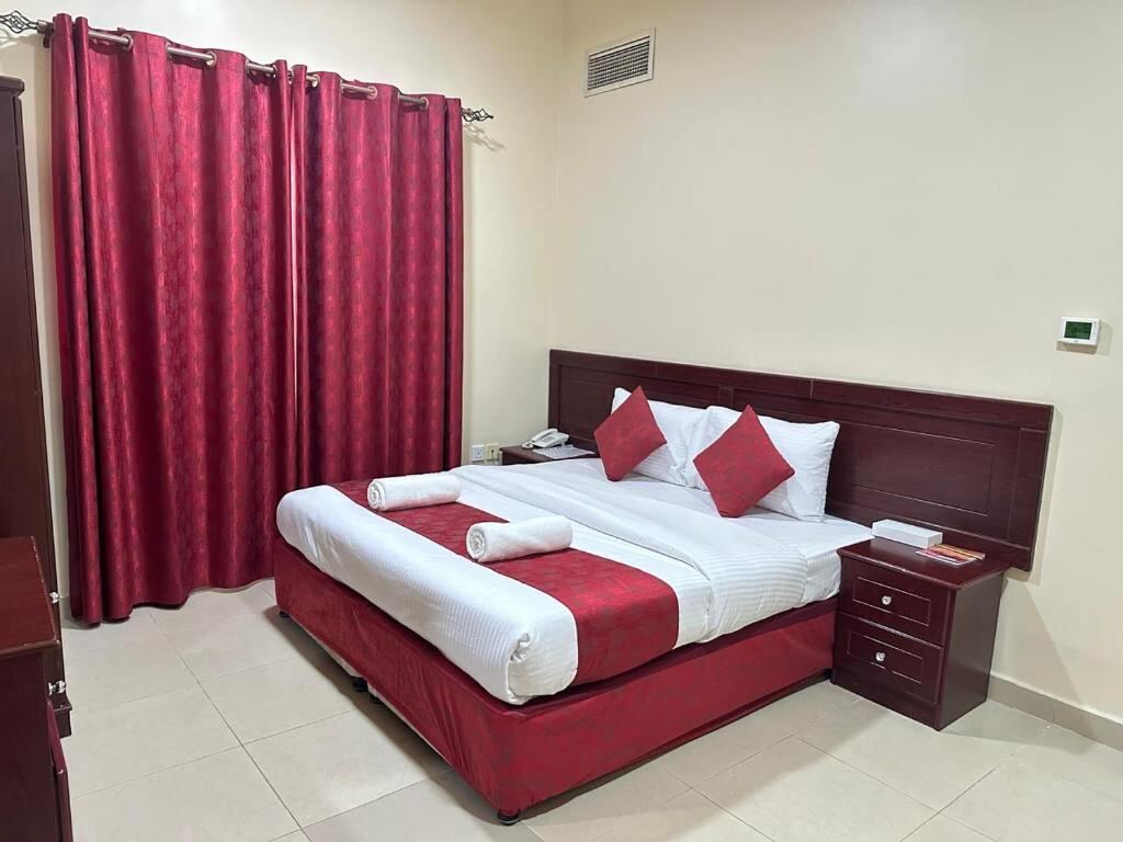 Bedroom with king bed at Al Reem Hotel Apartments