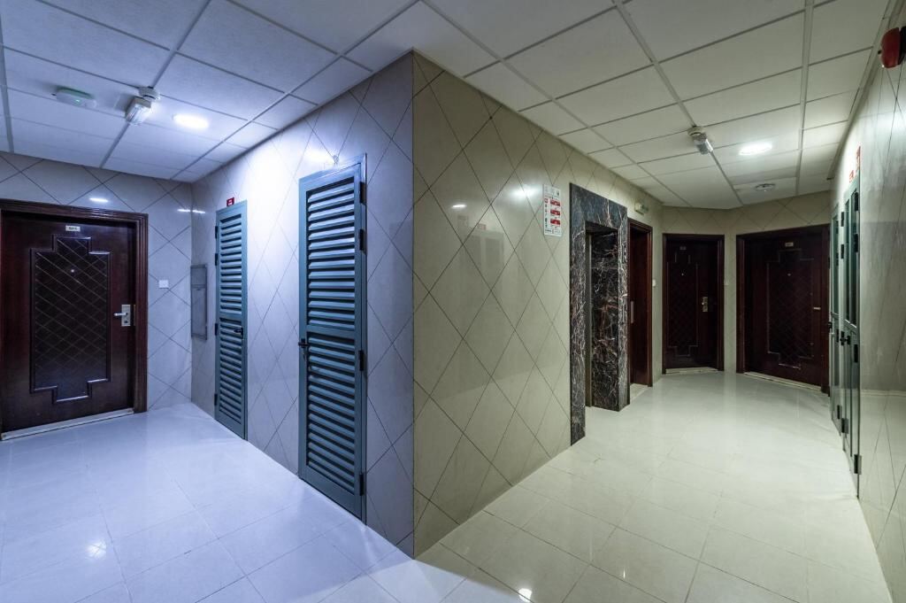Corridor with apartment doors inside Al Reem Hotel Apartments