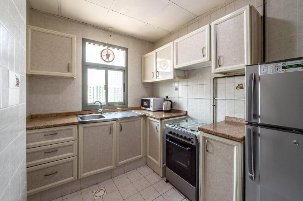 Private kitchen with fridge, oven and sink