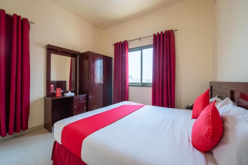 Apartment bedroom with wardrobe and window in Sharjah